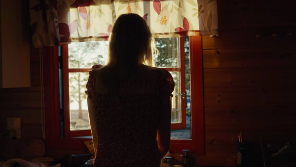 Woman Opens Window at Golden Hour in Swedish Archipelago Cabin