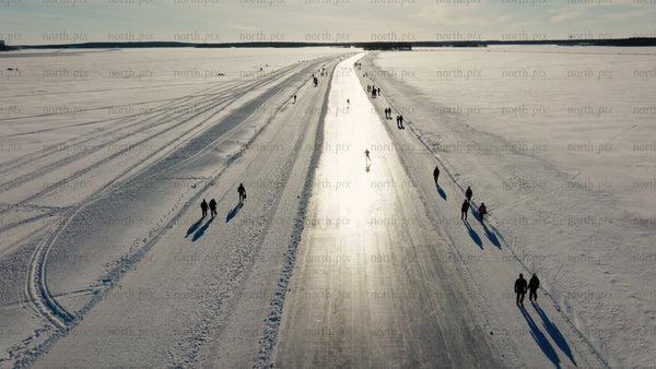 Ice skating and walking on a frozen lake in Luleå, on a winter day