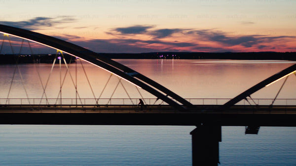 Sunset bike ride across Luleå bridge: An aerial view of summer