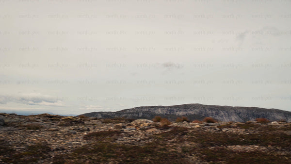 Mountain biker rides along rocky ridge with scenic mountain view