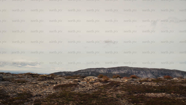 Mountain biker rides along rocky ridge with scenic mountain view