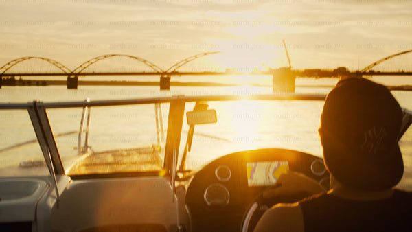 Boating on the Luleå river at sunset during golden hour, Luleå Sweden