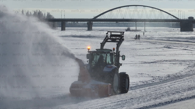Tractor Clearing Snow on Frozen River in Lulea, Sweden, Winter Landscape
