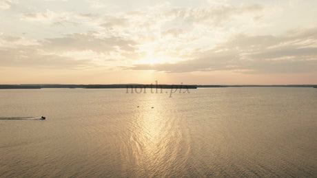 Sunset Over Calm Lake With Jet Ski and Kayaks in Lulea, Sweden