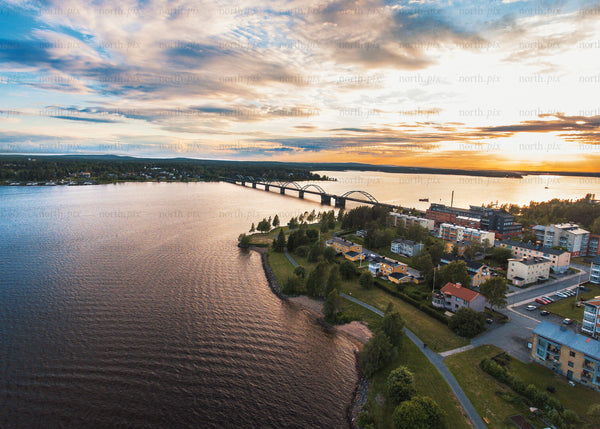 Aerial view of Luleå bridge and coastal town at sunset