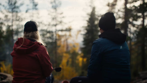 Couple enjoys autumn view in Luleå forest during golden hour