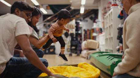 Family Shopping for Camping Gear With Their Toddler