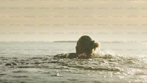 Woman swimming in the Baltic Sea, Luleå archipelago, summer