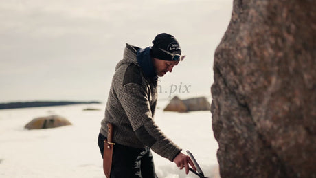 Man Cooking on a Portable Stove by a Frozen Lake in Lulea Archipelago Winter