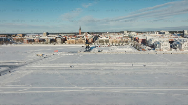 Winter in Luleå: Aerial view of frozen lake and city activities