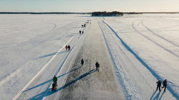 Ice skating and walking on a frozen lake in Luleå on a sunny winter day