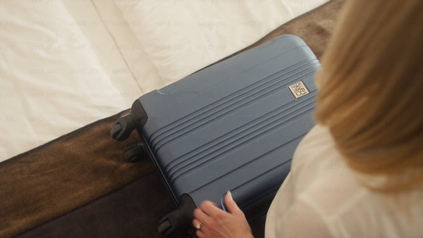 Woman unpacking suitcase in stylish hotel room after arriving in Luleå