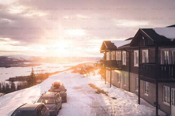 Wooden mountain lodge at sunset in winter