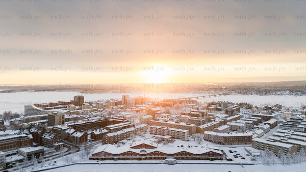 Aerial view of snowy cityscape at sunrise