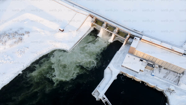 Aerial view of hydroelectric power plant in snowy winter landscape