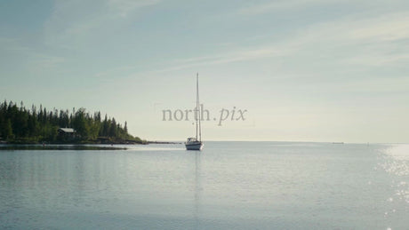 Summer Day in the Kluntarna Archipelago: Sailboat Moored Near a Lush Island in Lulea, Sweden