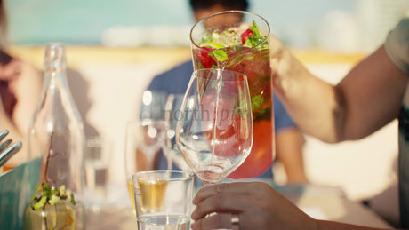 Friends Enjoying a Summer Rooftop Party with Refreshing Drinks