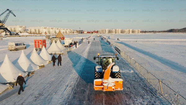 Winter day in Luleå: Tractor clears snow on frozen waterway