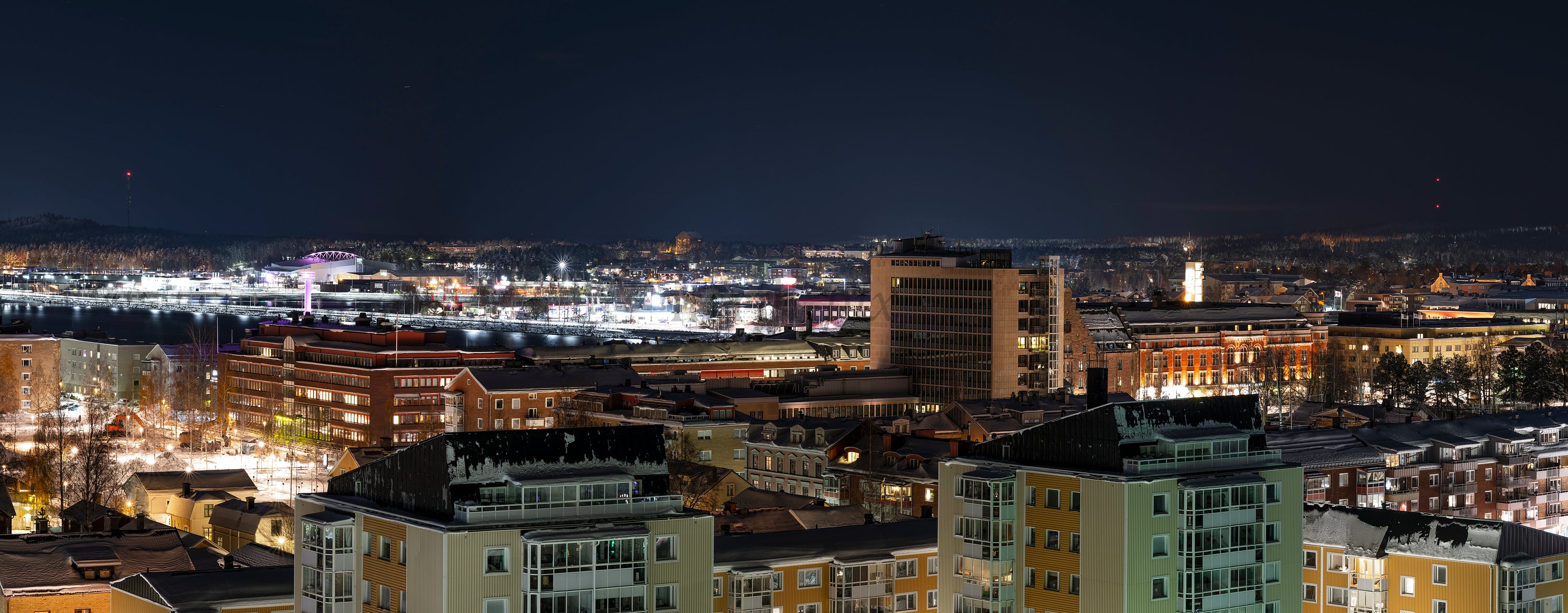 City skyline at night from elevated viewpoint