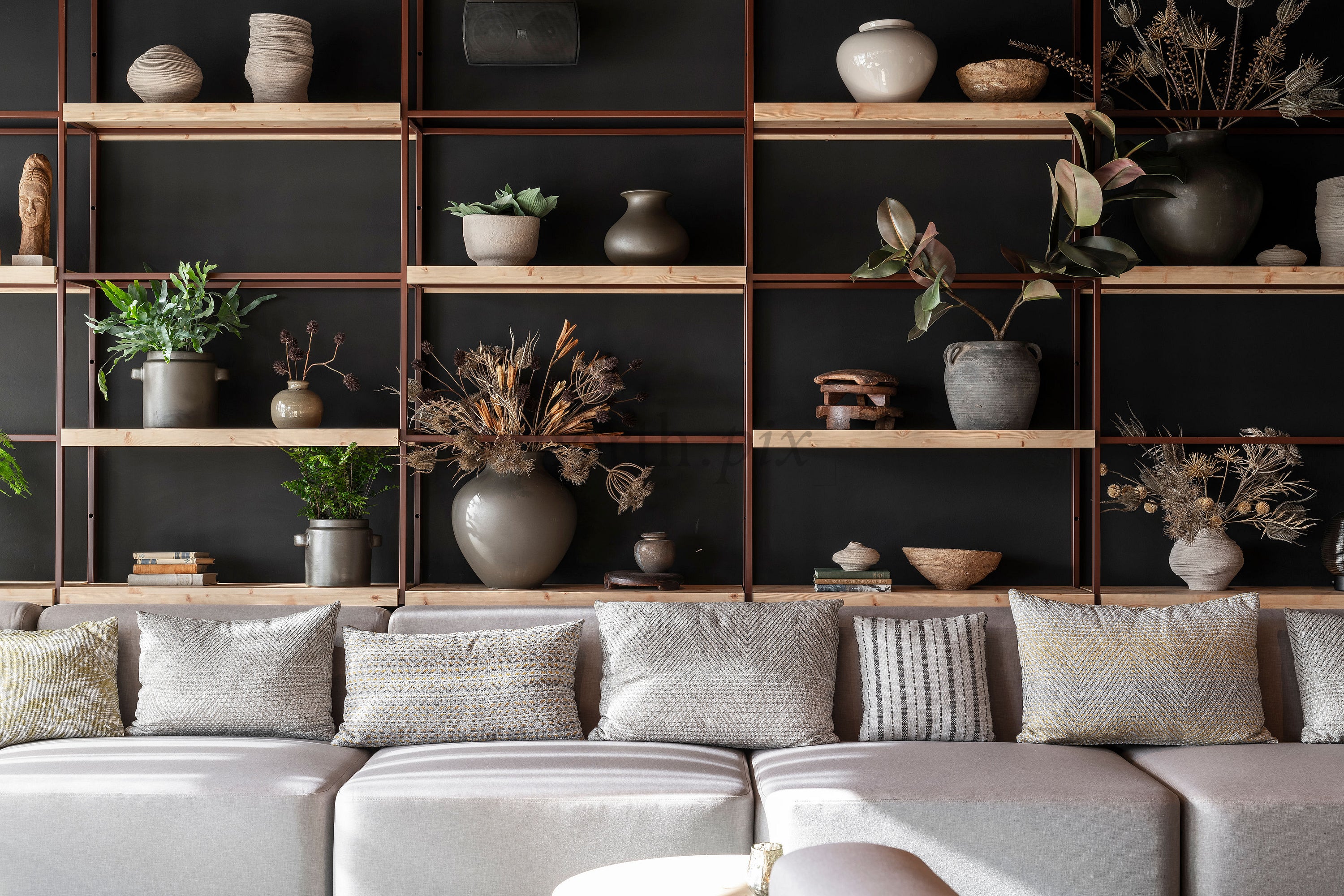 Sofa and open shelving with vases and plants, interior