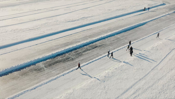 Winter ice skating on a frozen lake in Luleå - drone shot