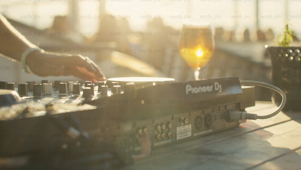 DJ mixing music at sunset: Summer vibes in Luleå