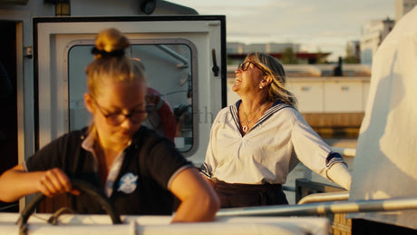 Golden Hour Laughter: Women Enjoy Sunset Boat Tour in Luleå, Sweden