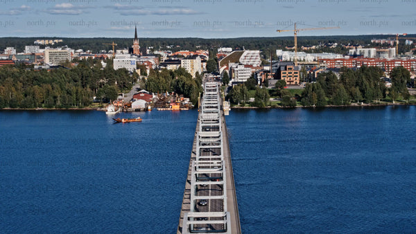 Aerial view of Luleå: Cars driving across Bergnäsbron bridge on a summer day