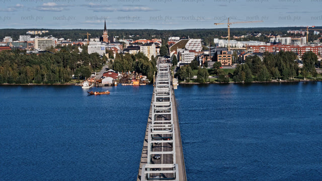 Aerial view of Luleå: Cars driving across Bergnäsbron bridge on a summer day