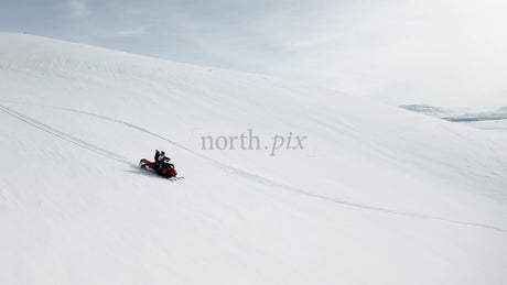 Snowmobiling Adventure: Two People Riding in a Winter Wonderland