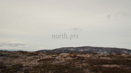 Mountain Biker Rides Along Rocky Ridge with Scenic Mountain View