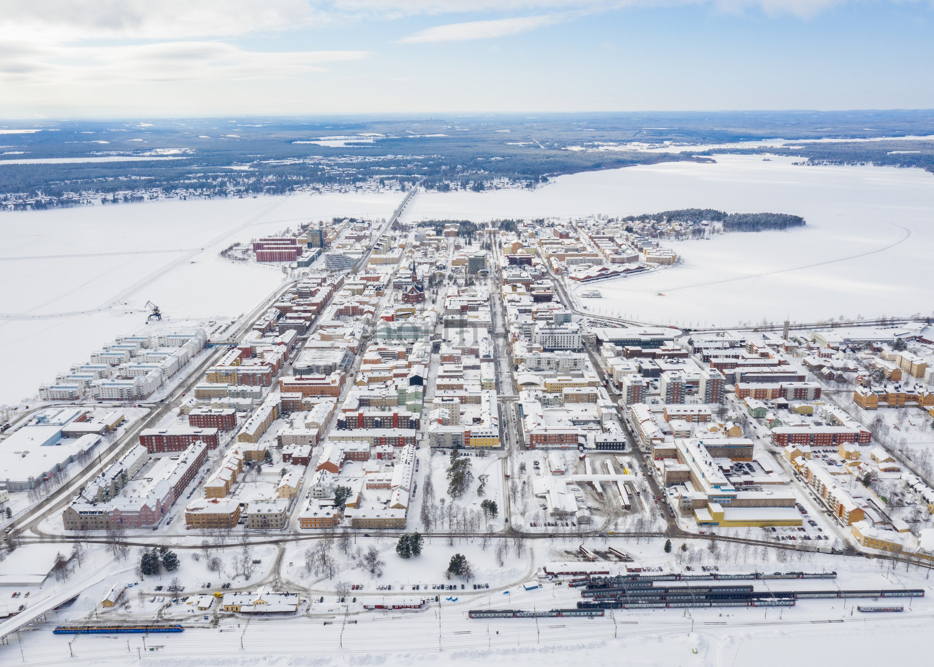 Winter Drone View of Luleå's Cityscape and Surrounding Snowy Landscape