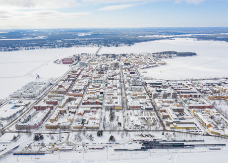 Winter Drone View of Luleå's Cityscape and Surrounding Snowy Landscape