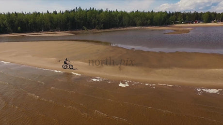Fatbike Rider in Sandön Archipelago, Luleå, Sweden: A Summer Day Drone Shot