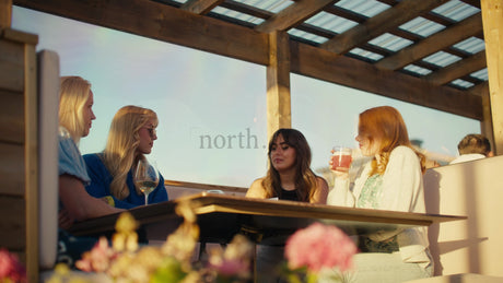 Friends Enjoy Summer Evening Drinks at Rooftop Bar in Lulea, Sweden