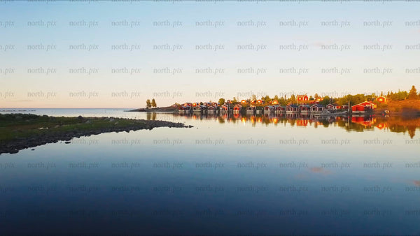Golden hour drone shot: Red cabins of the Luleå archipelago