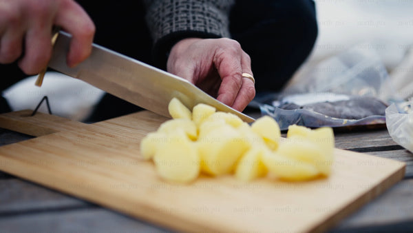 Cutting potatoes outdoors in winter, Luleå archipelago