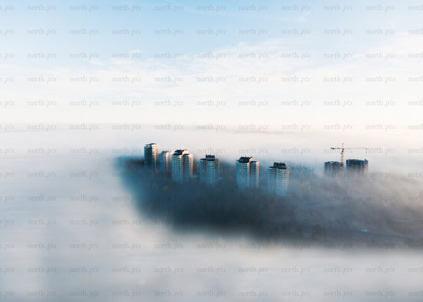 Foggy morning aerial view of urban towers and construction in Sweden