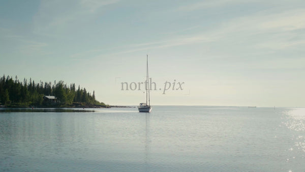 Summer Day in the Kluntarna Archipelago: Sailboat Moored Near a Lush Island in Lulea, Sweden