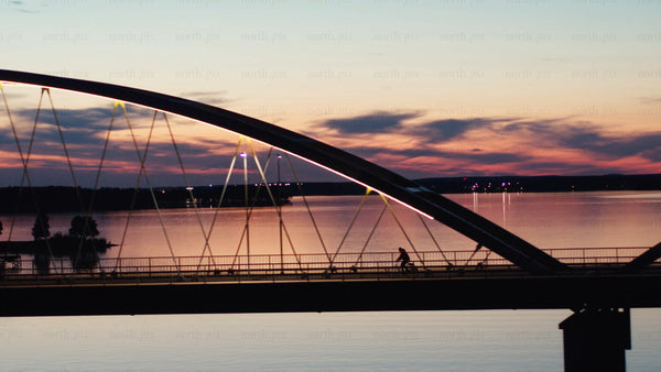 Sunset bike ride over Luleå river – aerial bridge view