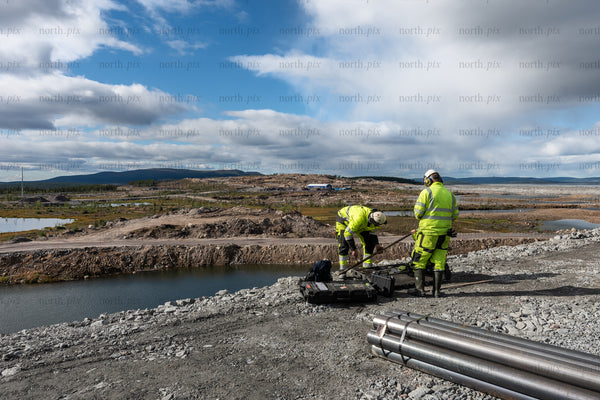 Construction workers at quarry site, daytime