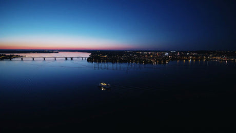 Aerial View of Lulea, Sweden at Sunset with Boat, Bridge, and City Lights