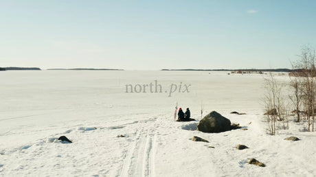 Winter Day in Luleå, Sweden: Two People by a Frozen Lake - Drone Shot