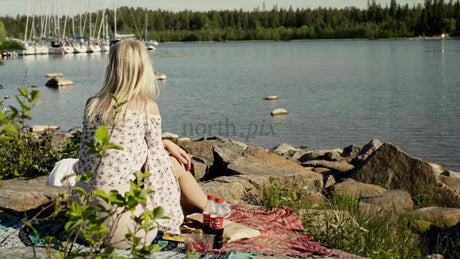 Summer Picnic in Lulea: Woman Relaxes by the Water in Kluntarna Archipelago, Sweden