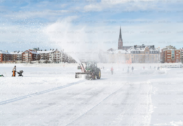 Tractor snow plow on frozen sea ice, Luleå winter