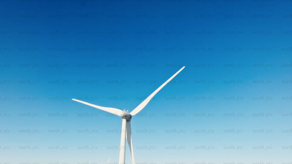 Wind turbine spinning in winter landscape: Sustainable energy in remote area