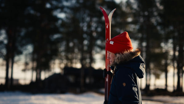 Winter day in Luleå: Person walks across snowy landscape with skis