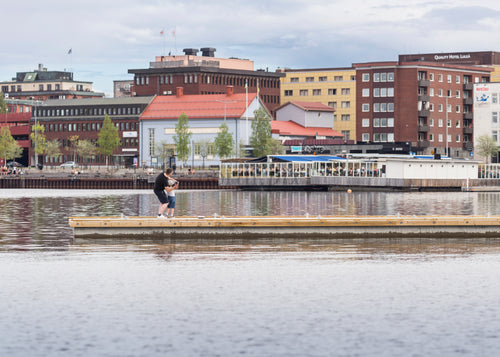 Two people on a dock in Luleå in summer