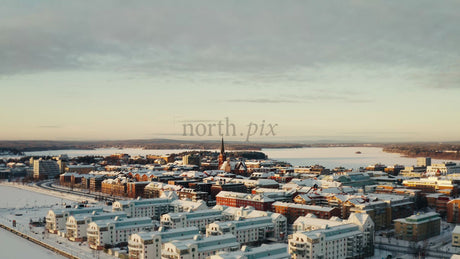 Winter Sunrise Over Luleå, Sweden: Aerial Drone Footage of Snow-Covered City