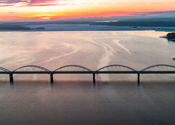 Sunset over Bergnäsbron in Luleå Sweden with aerial view of the bay